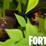 Fortnite player using sniper rifle through a bush