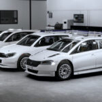 Three white rally cars all lined up to be customised in EA Sports WRC