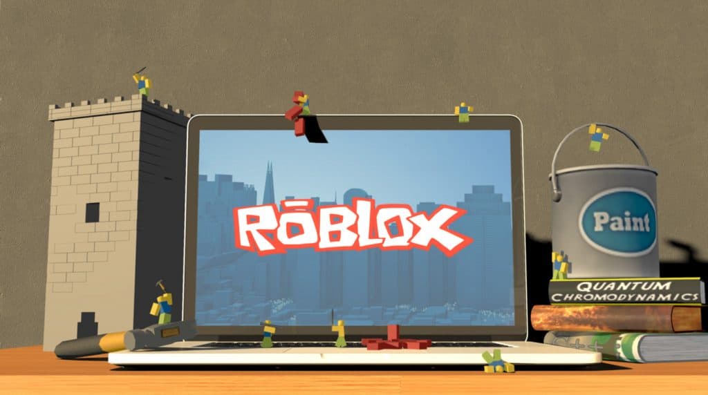 Una computadora portátil con personajes de roblox a su alrededor.