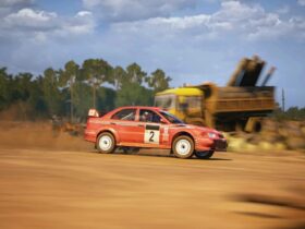 Mitsubishi Lancer Evo racing in dirt track in EA Sports WRC