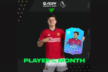 Harry Maguire holding his EA FC 24 POTM card