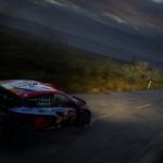 Car racing at night with headlights on in EA Sports WRC