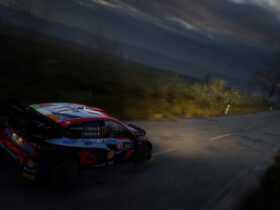 Car racing at night with headlights on in EA Sports WRC